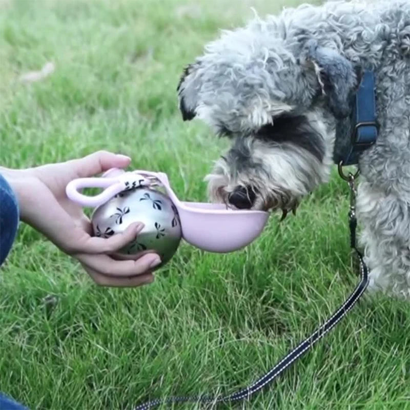 Dog drinking from HydroPaw portable water bowl during outdoor walk